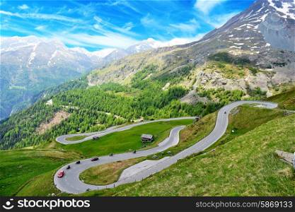 serpentine mountain road winds through valley