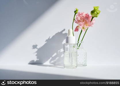 Serum with a dropper with beautiful spring flowers.. Serum with a dropper with spring flowers.