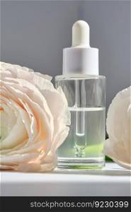 Serum with a dropper with spring beautiful flowers.. Serum with a dropper with spring flowers.