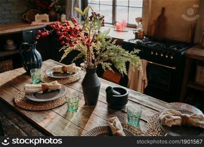 Served nicely decorated dining table with plates napkins vase. Kitchen background interior. Catering concept. Retro style. Interior design