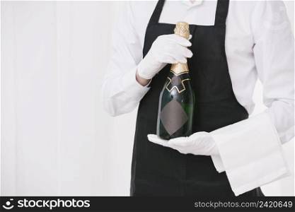 server holding bottle champagne