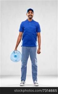 service and people concept - happy indian delivery man with water barrel in blue uniform over grey background. happy indian delivery man with water barrel
