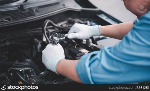 Service outdoor. Asian auto mechanic man working on car engine using wrench to repair and maintenance, broken car care check and fixed the problem and services insurance