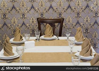 serving banquet table in a luxurious restaurant in beige and white style. served table in the restaurant