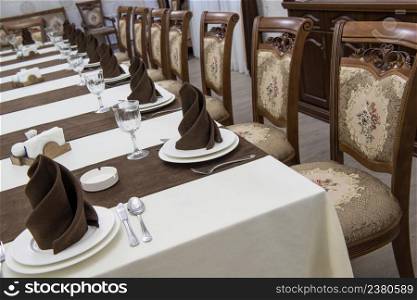 serving banquet table in a luxurious restaurant in brown and white style. served table in the restaurant