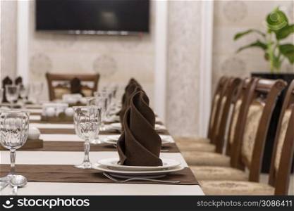 serving banquet table in a luxurious restaurant in brown and white style. served table in the restaurant