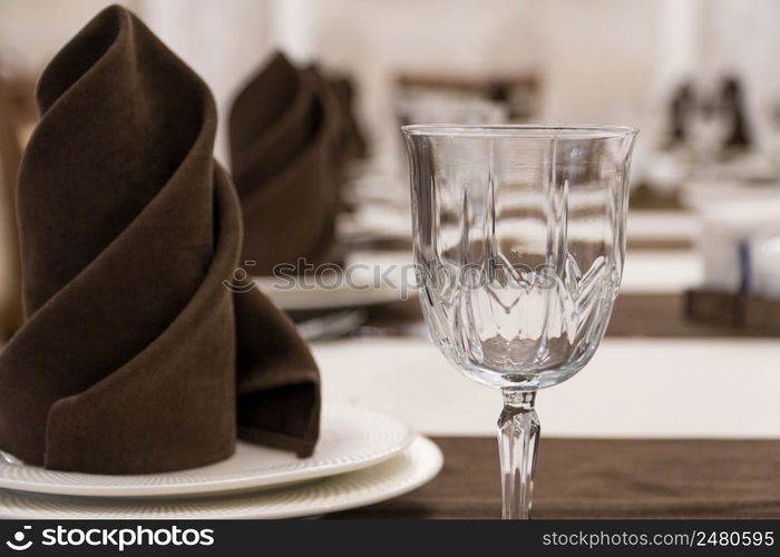 serving banquet table in a luxurious restaurant in brown and white style, macro shooting. served table in the restaurant