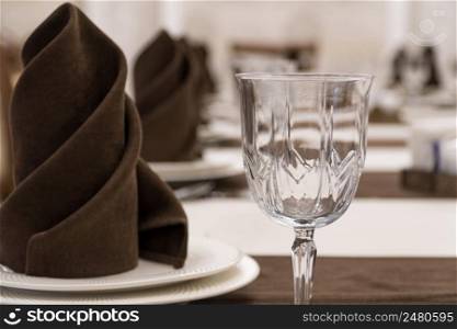 serving banquet table in a luxurious restaurant in brown and white style, macro shooting. served table in the restaurant