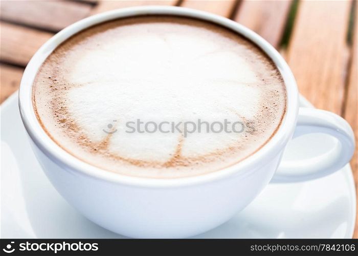 Serving cup of hot cafe mocha on wooden table