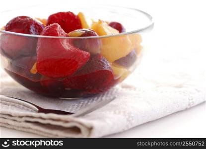 Serving of fruit salad with fork and napkin