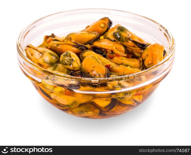 serving of pickled sea mussels in a glass bowl on a white background