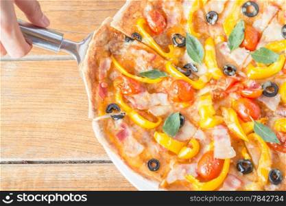 Serving piece of homemade pizza, stock photo