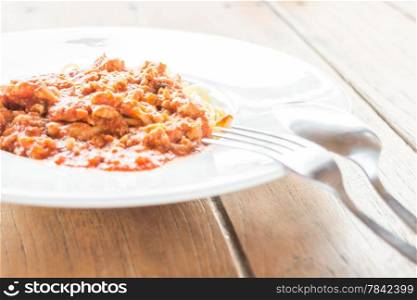 Serving plate of spaghetti tomato pork sauce, stock photo