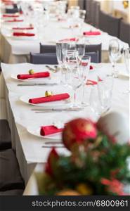 serving table for christmas dinner with red decoration nsapkins