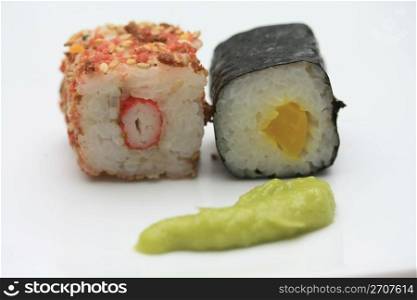 Sesame seed sushi, filled with raw crab and makisushi, made of seaweed and rice
