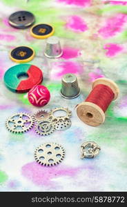 Set beads,threads and fittings on painted background.