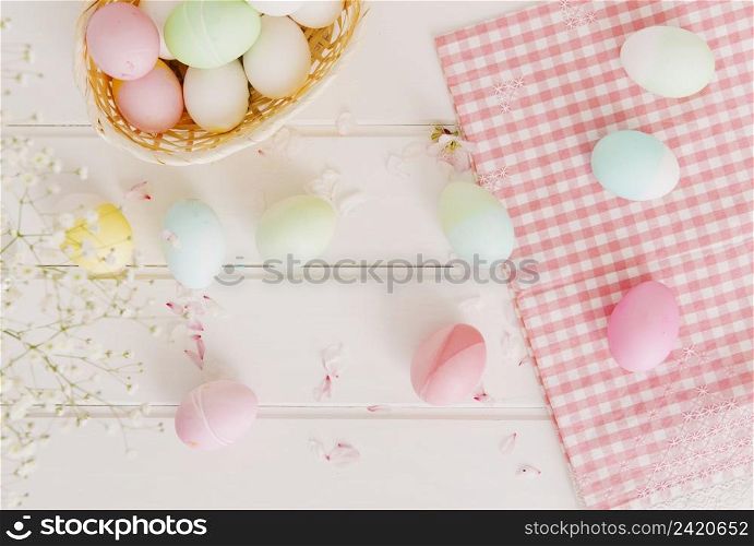 set easter eggs flower petals near napkin basket