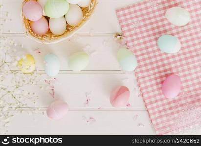 set easter eggs flower petals near napkin basket