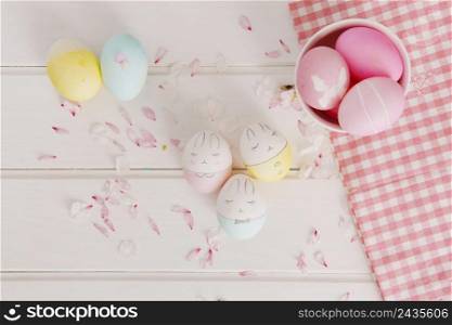 set easter eggs flower petals near napkin bowl