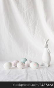 set easter eggs with patterns near figure rabbit