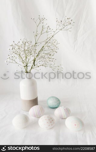 set easter eggs with patterns near plant twig vase