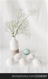 set easter eggs with patterns near plant twig vase
