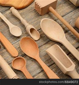 Set kitchen utensils on wooden table. Spoon, fork, rolling pin, hammer kitchen, kitchen spatula. Top view.