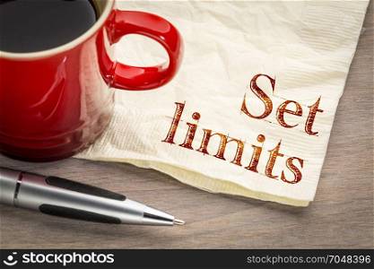 Set limits - productivity advice on a napkin with a cup of coffee