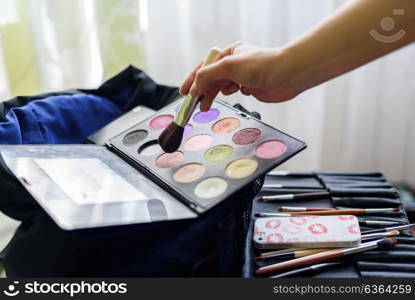 set make-up brushes and shadows on the table