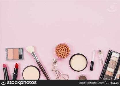 set makeup cosmetic beauty products pink background