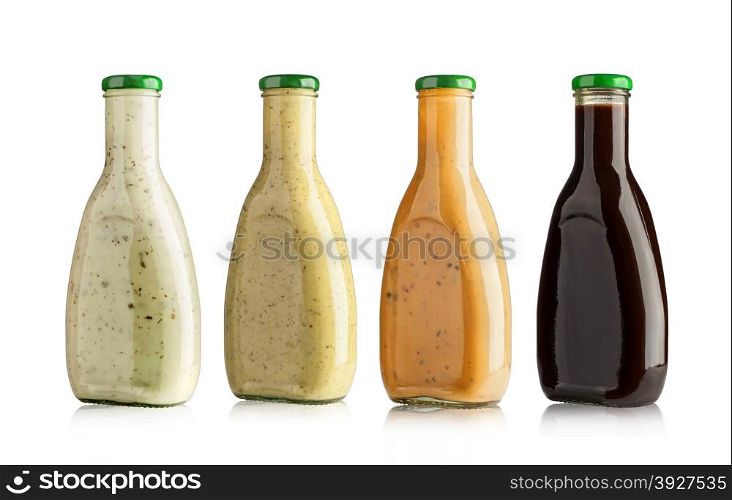 set of barbecue sauces in glass bottles on white background