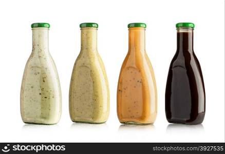 set of barbecue sauces in glass bottles on white background