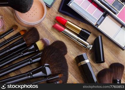 Set of  black professional brushes, lipsticks, eye shadows and  powder, top view . frame of make up 