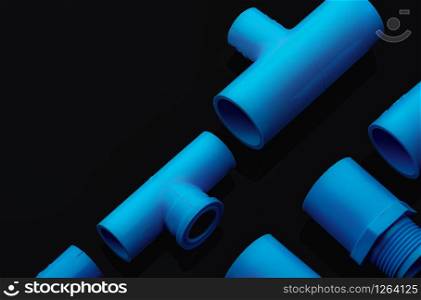 Set of blue PVC pipe fittings isolated on dark background. Blue plastic water pipe. PVC accessories for plumbing. Plumber equipment. Bend and three way connection plastic pipe for water drain sewage.