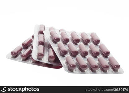 Set of brown pills in a blister pack on white background. Set of brown pills in a blister package on white background