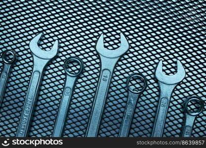 Set of chrome wrenches on steel surface. Mechanic tools for maintenance. Hardware tools to fix. Technical tools background. Set of chrome wrenches on steel surface. Mechanic tools for maintenance. Hardware tools to fix. Technical tools background with copy space