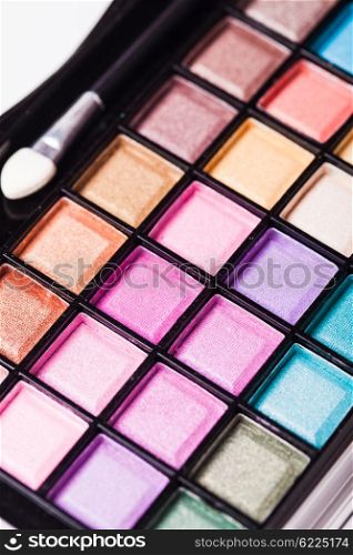 Set of colored powder with brush for make-up in a plastic case. Bright eyeshadow palette