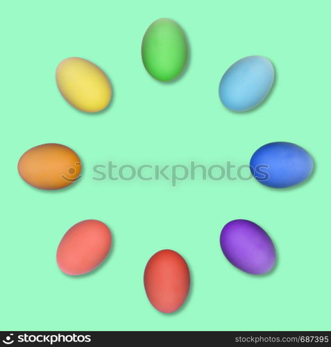 Set of colorful Easter eggs grouped in a circle isolated on green background.