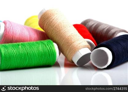 Set of colorful spools of thread isolated on white background