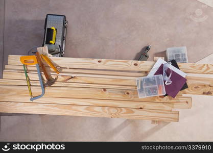 Set of construction tools lying on wooden plank