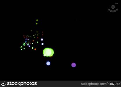 Set of defocused light spots on black background