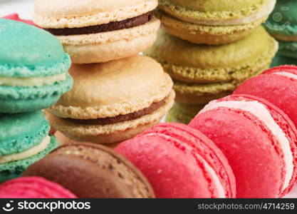 Set of delicious macaroons. Many colourful tasty macaroons in a row