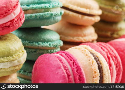 Set of delicious macaroons. Many colourful tasty macaroons in a row