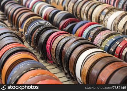 Set of different and colorful leather belts as a background