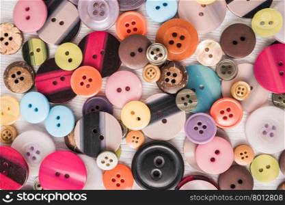Set of different colored buttons on white background. Top of view