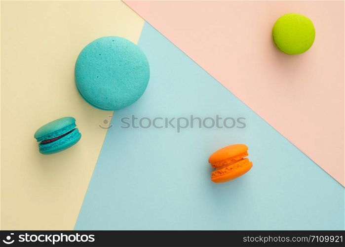 Set of different colorful macaroons on many colors background. Sweet and tasty for cooking and restaurant menu. Top view