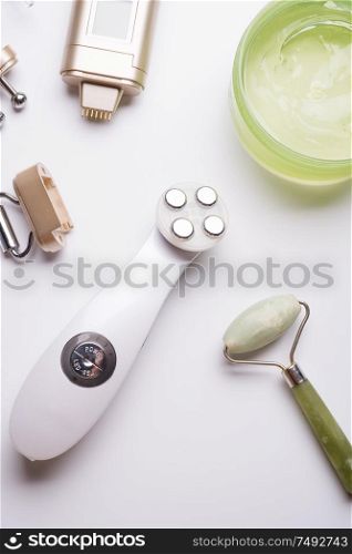 set of different hardware equipment with vacuum jars, nephrite roll and massage brush. anti-age and anti-cellulite set for home skin care procedure. beauty concept