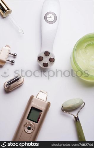 set of different hardware equipment with vacuum jars, nephrite roll and massage brush. anti-age and anti-cellulite set for home skin care procedure. beauty concept