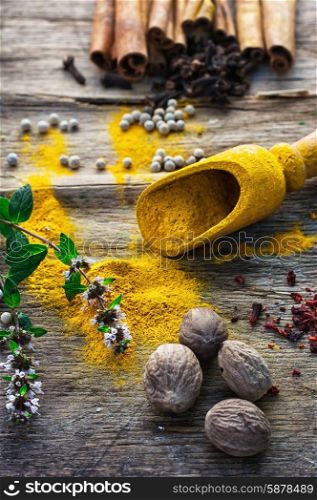 Set of different spices on the old wooden table.