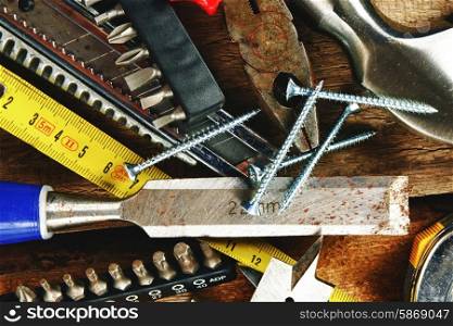 Set of different tools on wooden background